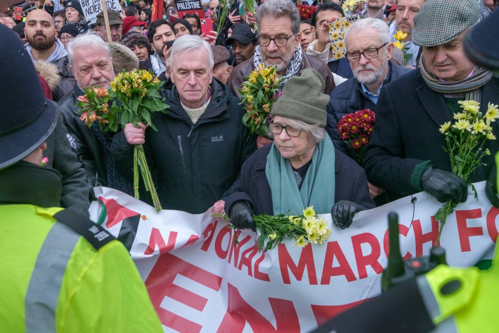 12 Days of Christmas,  Police take protesters carrying bunches of flowere through line and then arrest them